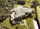 Aerial view of a completed residential remodel surrounded by mature trees