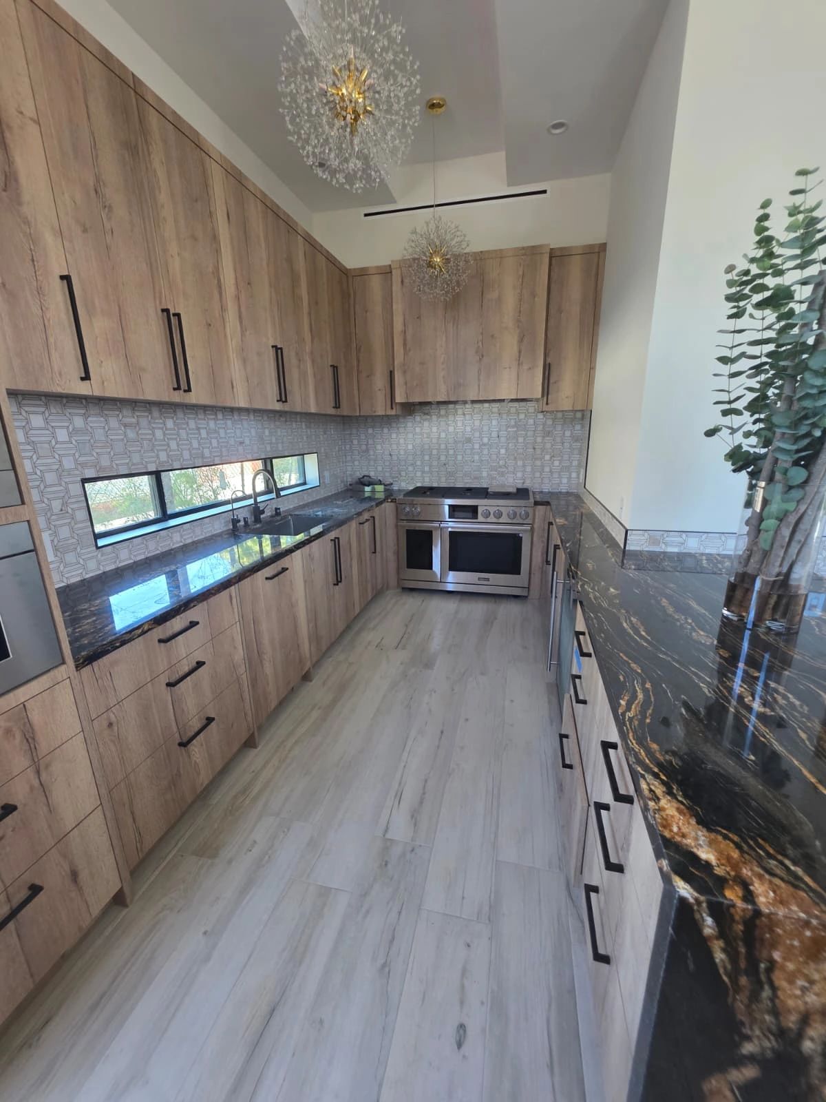 Light wood kitchen with open shelving and quartz countertops